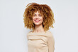 © SHOTPRIME STUDIO - Happy woman with curly hair smiling against a light background, showcasing her vibrant personality and natural beauty in a casual setting Her joyful expression radiates warmth and confidence