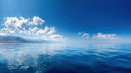 Wall Mural - Panoramic Seascape View with Cloud Reflections on Calm Blue Sea Under Clear Sky