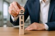 © Generative AI - Financial Debt Concept: Hand Stacking Wooden Blocks Spelling Debt, Representing Financial Burden and Economic Challenges