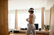 © Malquerida Studio/Stocksy - Woman doing fitness with VR glasses at home