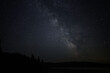 © Carol Hamilton - A night scene of a star filled sky and a faint glow of the Milky Way over a calm fresh water lake
