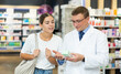 © JackF - Male pharmacist gives advice to a girl what medicinal ointment to buy