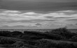 © JIE MA/Stocksy - Distant dialogue between coastal rocks and Mount Fuji.