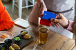 © Basil Pind/Stocksy - Close-up of card payment at restaurant table