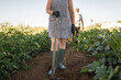 © Lupe Rodriguez/Stocksy - unrecognizable woman tilling the land in her garden