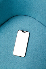 Mockup Phone with White Screen on Blue Sofa 