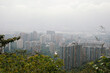 © Laura Herrera/Stocksy - Cityscape view from a hillside surrounded by misty weather