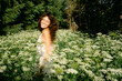 © Lea Jones/Stocksy - young woman in a field of wild flowers