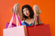 © Roman Shalenkin/Stocksy - Asian beautiful happy young woman with shopping bags