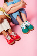 © Peninsula/Stocksy - Colorful Kids' Sneakers on Pink Background