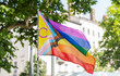 © Luis Velasco/Stocksy - Progress Pride Flag Waving Outdoors