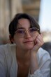 © Studio Sincère/Stocksy - Portrait of a Young Woman With Glasses Enjoying a Sunny Day