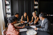© BONNINSTUDIO/Stocksy - Lawyers team discussing legal case in modern office