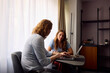 © Boris Jovanovic/Stocksy - Colleagues are consulting while using a laptop