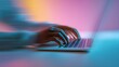 © World Images - A close-up of a person's hands typing on a laptop keyboard with a pink and blue background and motion blur