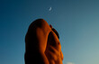 © Ivan Andrianov/Stocksy - Sensual Meditative Person and Crescent Moon At Sunset