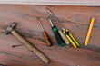 © Olga Prahoda/Stocksy - Tools arranged on wooden surface for repair tasks