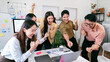 © NAMPIX - A cheerful and diverse business team celebrates a successful project