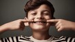 © Eve - Smiling boy with braces pointing at teeth