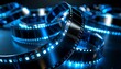 © Arif - Glowing blue film reels intertwined on dark background