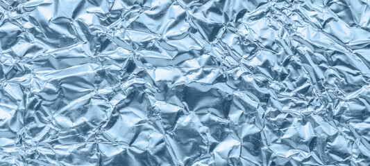 Wall Mural - shiny metallic blue foil crumpled texture background