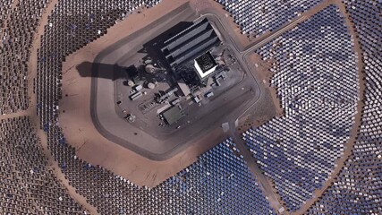 Aerial view of the Ivanpah Solar Electric Generating System, a vast array of mirrors reflecting sunlight towards a central power tower, San Bernardino County, United States.