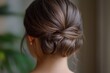 © Thanapong - Elegant chignon bun hairstyle with refined and smooth texture, perfect for formal occasions. hair is styled in classic updo, showcasing sophisticated and polished look