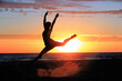 © antoine - Beautiful girl silhouette dancing on the beach, in the sunset