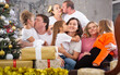 © caftor - Family with children on sofa in christmas interior