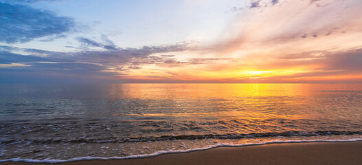 Wall Mural - panoramic sunset sky clouds over sea water background in evening orange, blue sun light, horizon sea