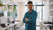© Monkey Business - Portrait Of Young Smiling Businessman Standing In Modern Office