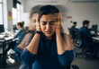© Autism in Focus - Autistic young indian woman with headphones in office eyes closed distressed showing sensory overload anxiety panic attack meltdown motion blur long exposure