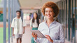 © Monkey Business - Portrait Of Smiling Female High School Or Secondary Teacher With Digital Tablet Outdoors At School