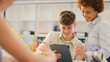 © Monkey Business - Female Teacher With Male High School Student Using Digital Tablet In STEM Class