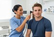 © Anna - Doctor conducting ear examination on young male patient in medical office