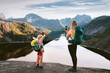 © EVERST - Family travel in Norway mother hiking with child taking photo using smartphone mountains and lake view explore Lofoten islands together, active summer vacations backpacking trip outdoor