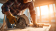 © plaksa - Caucasian construction contractor operating a cordless circular saw, cutting plywood indoors, wearing protective gloves and plaid shirt, safety glasses, dynamic low-angle close-up,