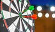 © NurNazira - Darts Hitting Target on Dartboard with Colorful Arrows and Lighting