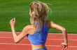© Yevhen - Young sportswoman sprint on a running track outdoors on stadium. Strong athlete girl runner exercise and practicing workout speed running marathon on the race for competition