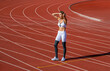 © Yevhen - Break, tired woman at stadium for a workout, training or breathing after cardio. Tired girl on stadium. Sports, race and an athlete runner, fitness, running or exercise on track