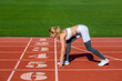 © Yevhen - Athlete on the starting. Young sportswoman sprint on a running track outdoors on stadium. Girl at the start is ready to run and win. Female athlete alone on the athletic track, sprint running