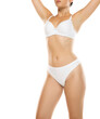 © vladimirfloyd - Studio shot of woman in white lingerie, arms up, showing toned body, white background
