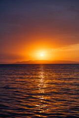Wall Mural - Beautiful sunset over the lake and mountains.