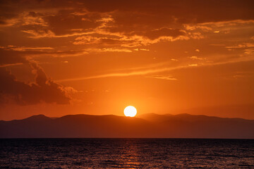 Wall Mural - Beautiful sunset over the lake and mountains. 
