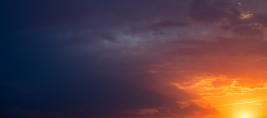 Wall Mural - Bright orange sunset sky background with dramatic clouds. 