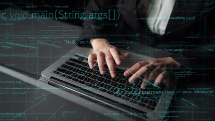 Wall Mural - a close-up view of a person hands typing on a laptop keyboard, with programming code overlays creati