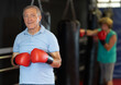 © JackF - Elderly man trains in the gym - practicing punches on a punching bag