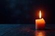 © Kathy - A single candle emits warm light in a darkened space, serene scene, lone light, shadows