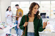 © Home-stock - Positive woman choosing to buy medicine, holding package and smiling. Modern pharma store shelves with health care products