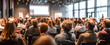 © Daniel - The audience engaged in a corporate presentation within a modern conference setting.